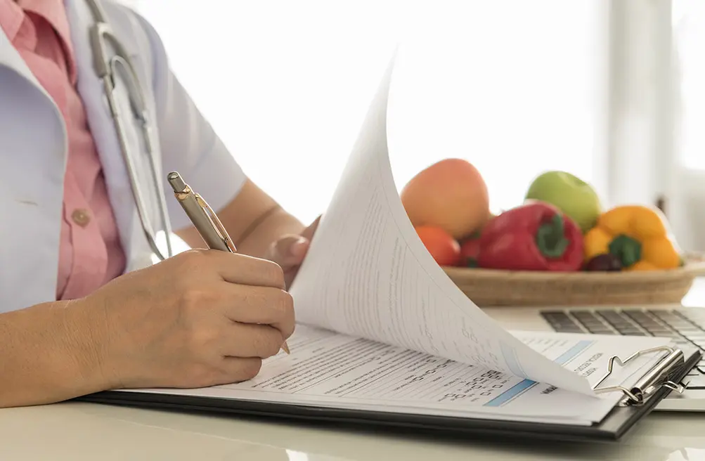 A Trillium Woods health and wellness navigator fills out paperwork