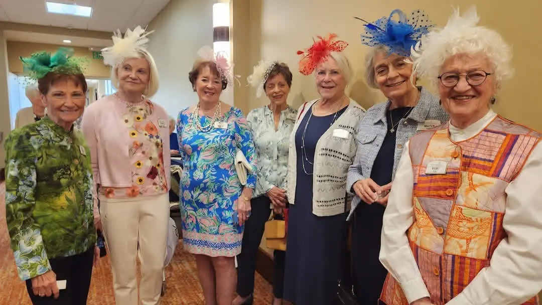 Senior women wearing fancy hats at an event at Trillium Woods