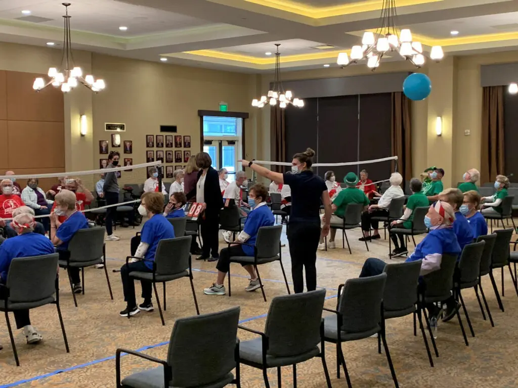Residents at Trillium Woods play chair volleyball