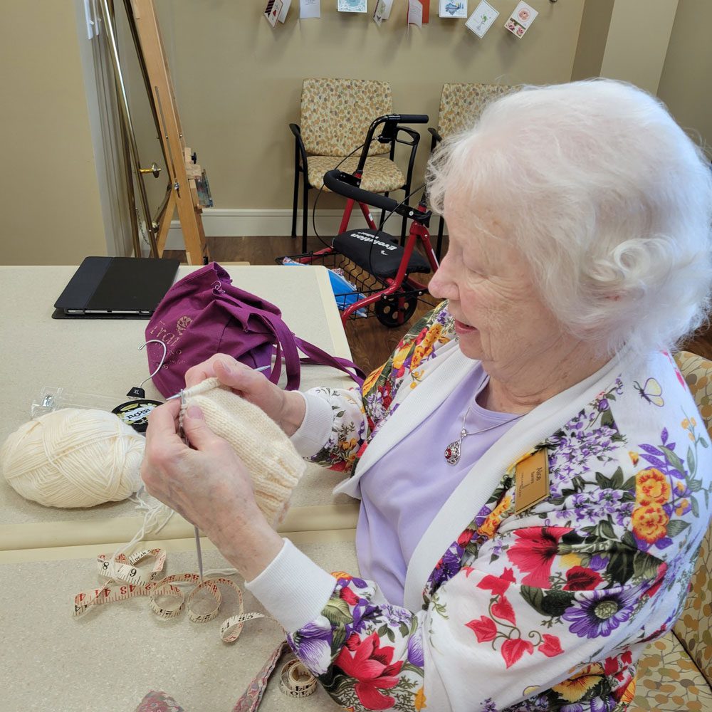 Senior woman knitting at home