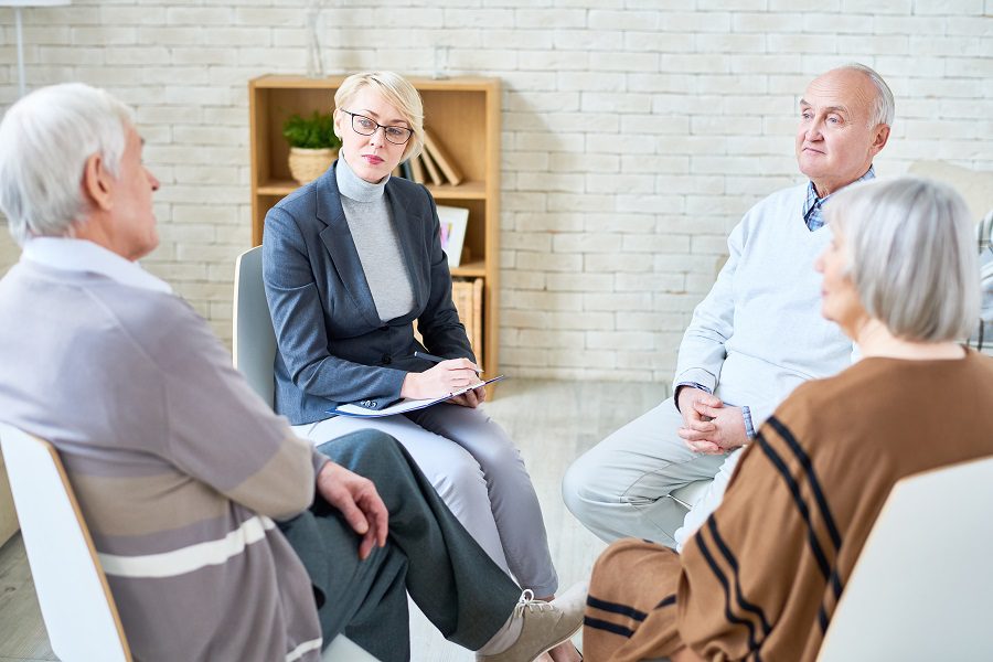 Senior couple speaking with advisor