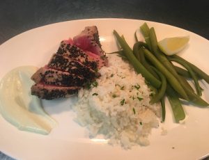 dinner plate with tuna steak, white rice, and green beans