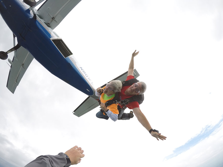 A resident and instructor parachute out of a plane together.