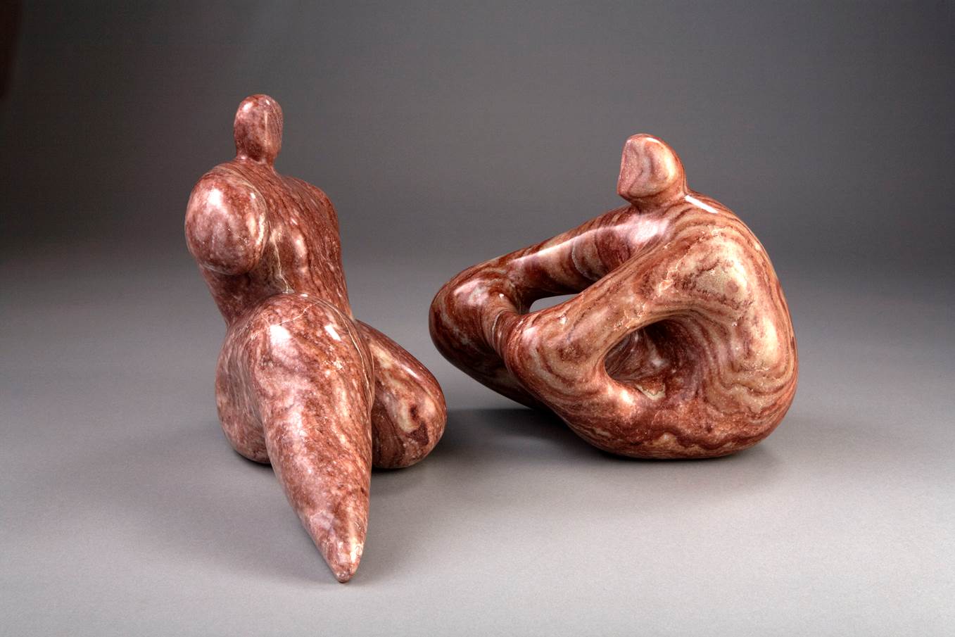 Two small stone sculptures of people