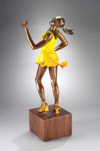 bronze statue of a woman in a yellow dress at trillium woods
