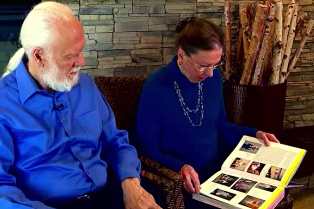 Senior living residents looking through album